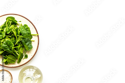 green salad mix on plate with salt for healthy food on white background top view mock up