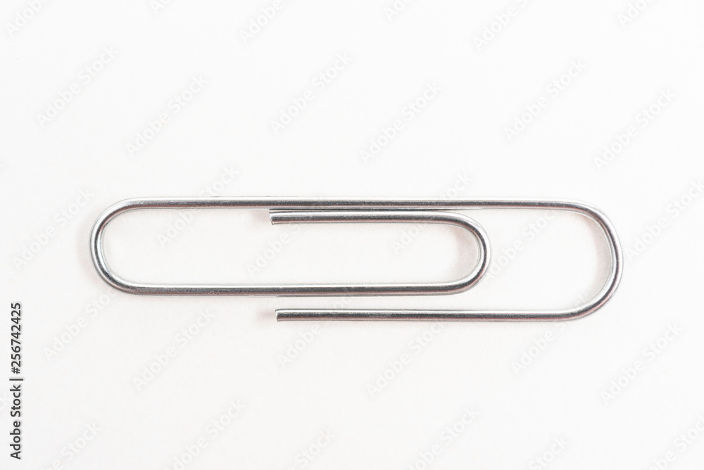 A horizontal macro shot of a common paper clip set on a white background. A horizontal macro shot of a common paper clip set on a white background.