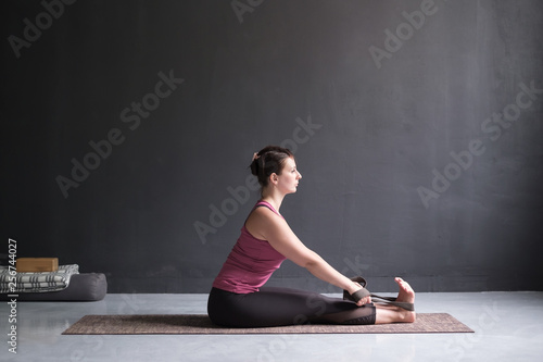woman practicing yoga, Seated forward bend pose