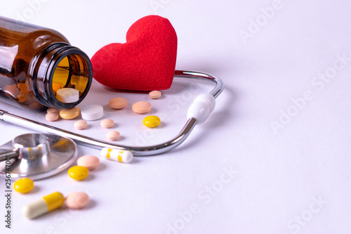 The heap color mix tablets pills drug with wooden background. World health day. Pharmacy industry.