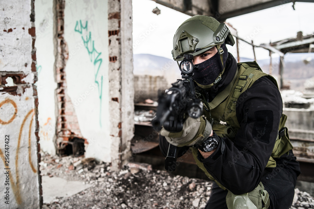 Special forces police soldier in action battle ruined building aiming riffle Special forces police soldier in action battle ruined building aiming riffle