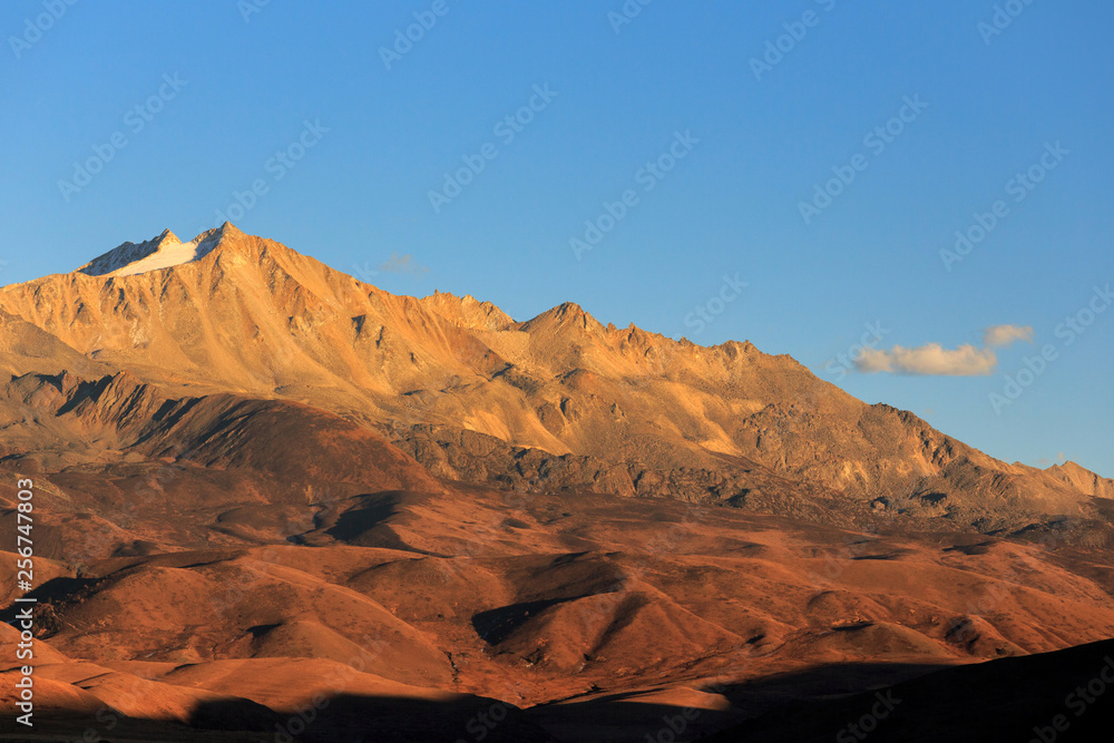 Abstract Landscape. Blue Open Sky, High Altitude Brown Mountains and Hills in the distance. Minimal Background, Open Space, Negative Space. Sichuan Province China. Tibetan Plateau Landscape