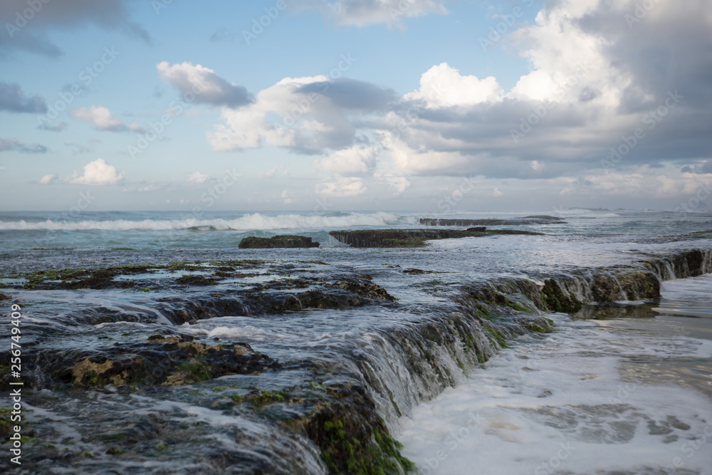 Sea waves broken on seaside rocks
