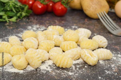 Uncooked fresh homemade gnocchi. Italian cuisine - raw gnocchi, made of potato, flour and egg.  photo