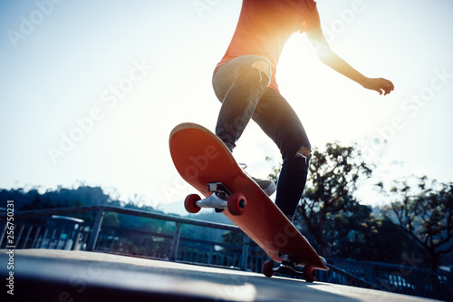 Skateboarder skateboarding at skatepark ramp