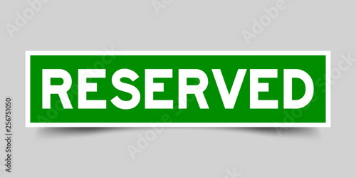 Green color sticker in word reserved on gray background