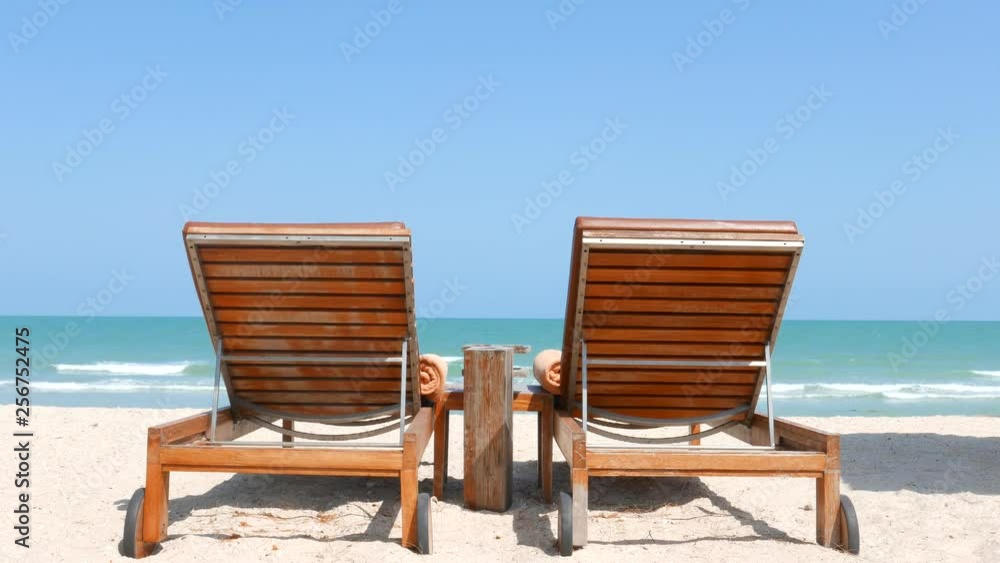 Wooden Beach Beds on Tropical Sandy Beach With Look on Turquoise Sea Water Clear Blue Sky and Horizon Wooden Beach Beds on Tropical Sandy Beach With Look on Turquoise Sea Water Clear Blue Sky and Horizon