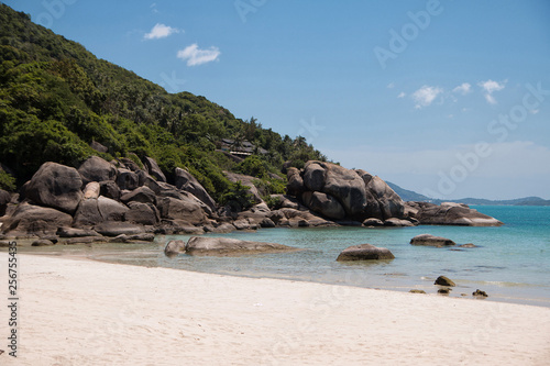 Turquoise water, granite rocks and tropical trees in the white sand