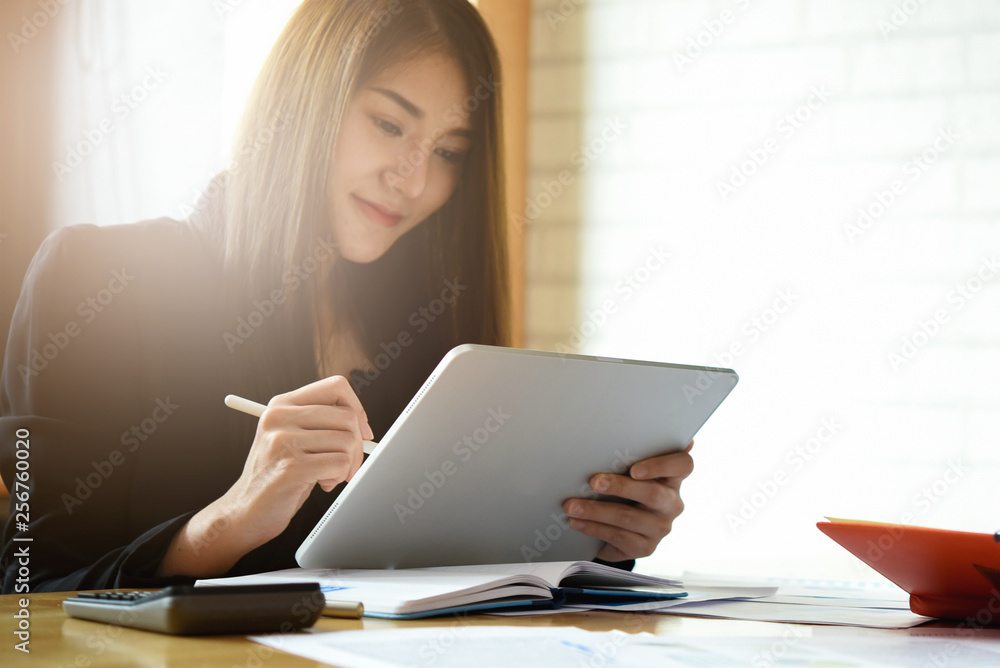 Businesswoman working with digital tablet computer for financial analysis Businesswoman working with digital tablet computer for financial analysis
