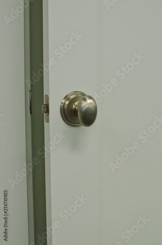 A slighty ajar door in the showroom with a view of the new designs. 