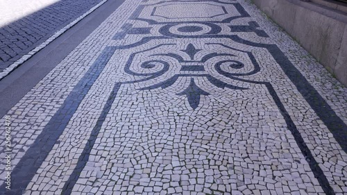 Traditional Portuguese pavement / sidewalk in Porto city, Portugal. Pan up.