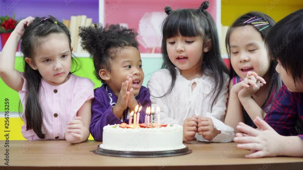 Group diversity kids blowing birth day cake. Group diversity kids blowing birth day cake.