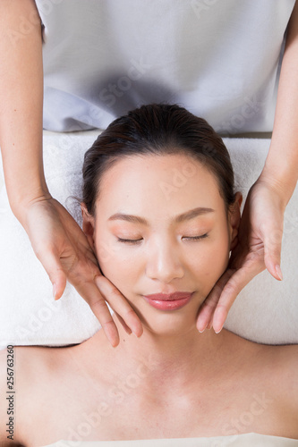Ayurvedic Head Massage Therapy on facial forehead Master Chakra Point of Asian woman, Therapist Spa body woman hands treatment on customer to increase circulation release tension stress of think work