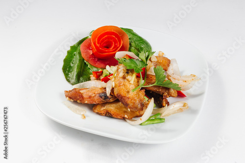 Traditional oriental cuisine of Vietnam. Breaded Chicken Wings with green salad and tomato
