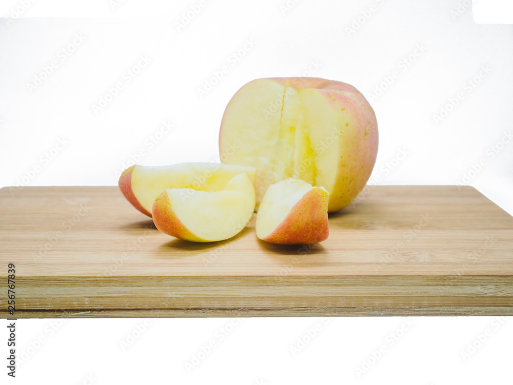 Apple was sliced on wooden board on isolate background