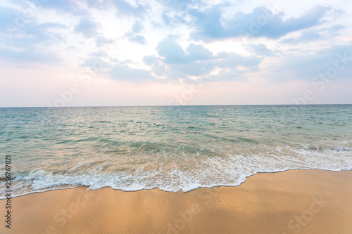 Clean sand on the beach have sea wave coming up, with soft blue sky with cloudy and small sunset © TeeRaiden