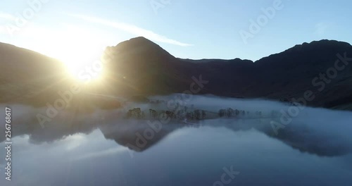 Aerial shot of sunrise over foggy Buttermere in the English lake district. photo