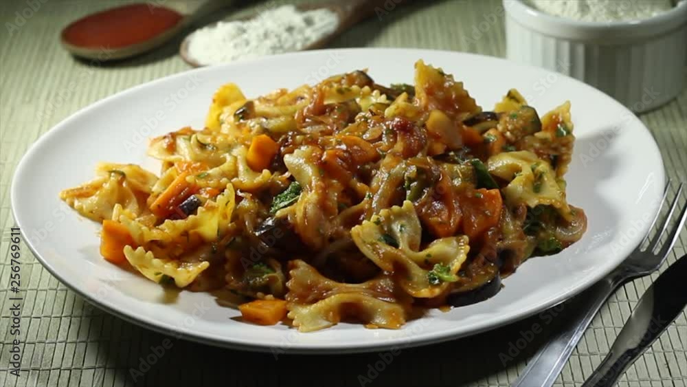 Delicious italian meal known as farfalle made with a spicy and juicy sauce Delicious italian meal known as farfalle made with a spicy and juicy sauce