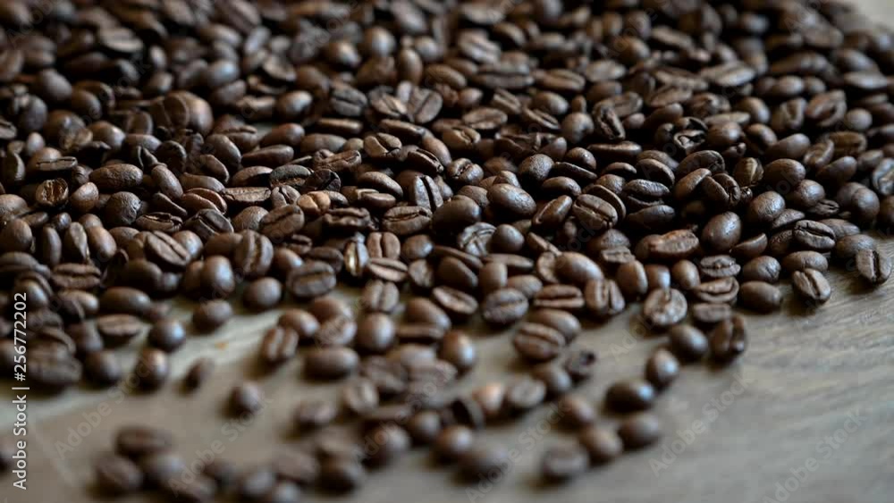 Roasting coffee beans falling to the ground Roasting coffee beans falling to the ground