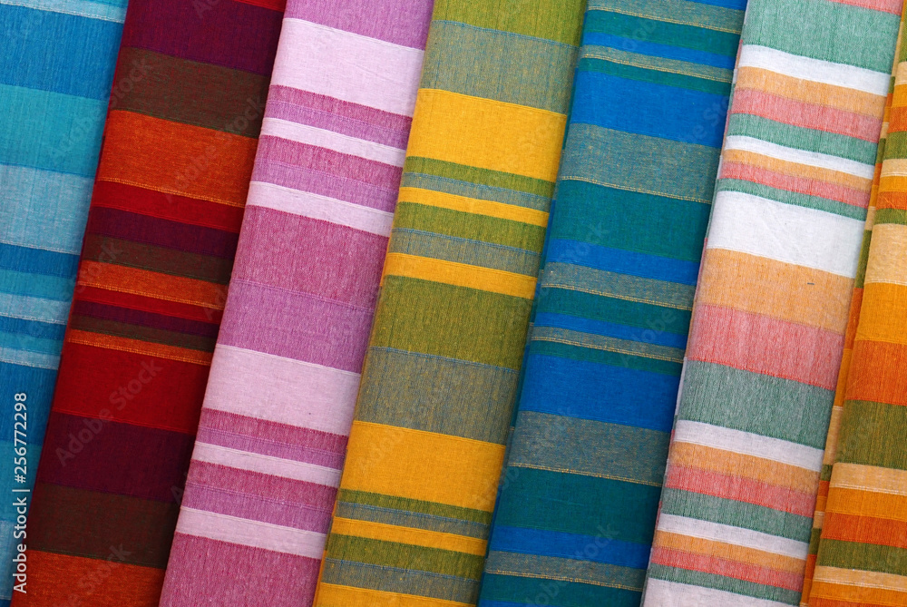 Closeup of folded striped bed sheets in display in a shop, for use as background Closeup of folded striped bed sheets in display in a shop, for use as background