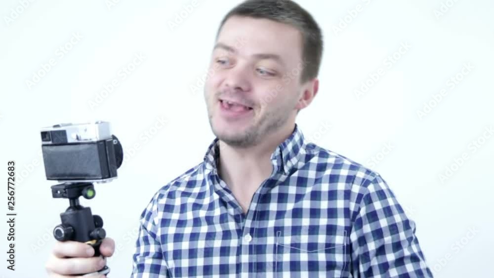 Young beautiful funny man blogger shooting blog or having video chat Young beautiful funny man blogger shooting blog or having video chat