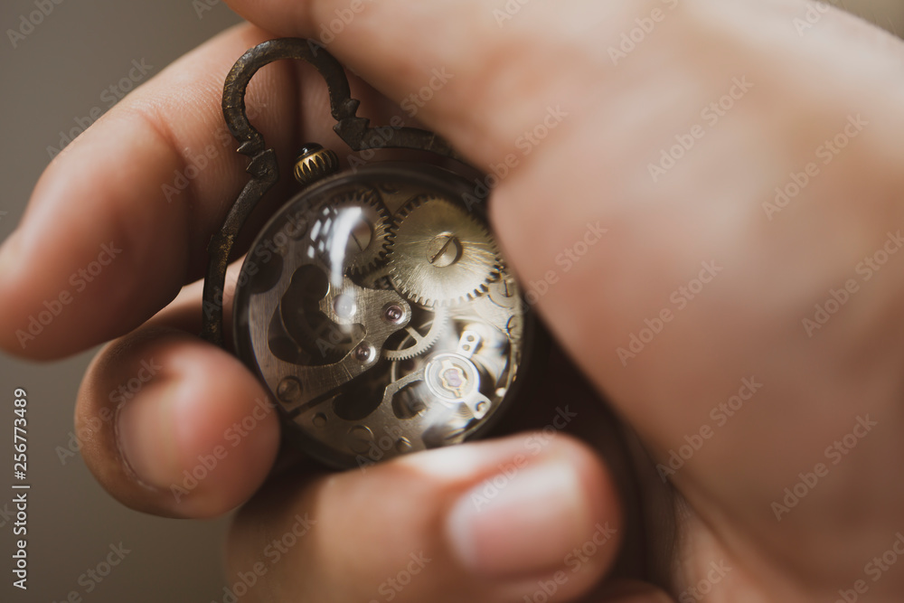 Antique watch in hand represent of profesional investment with good asset make growth money of profit return, business and finance concept. Antique watch in hand represent of profesional investment with good asset make growth money of profit return, business and finance concept.