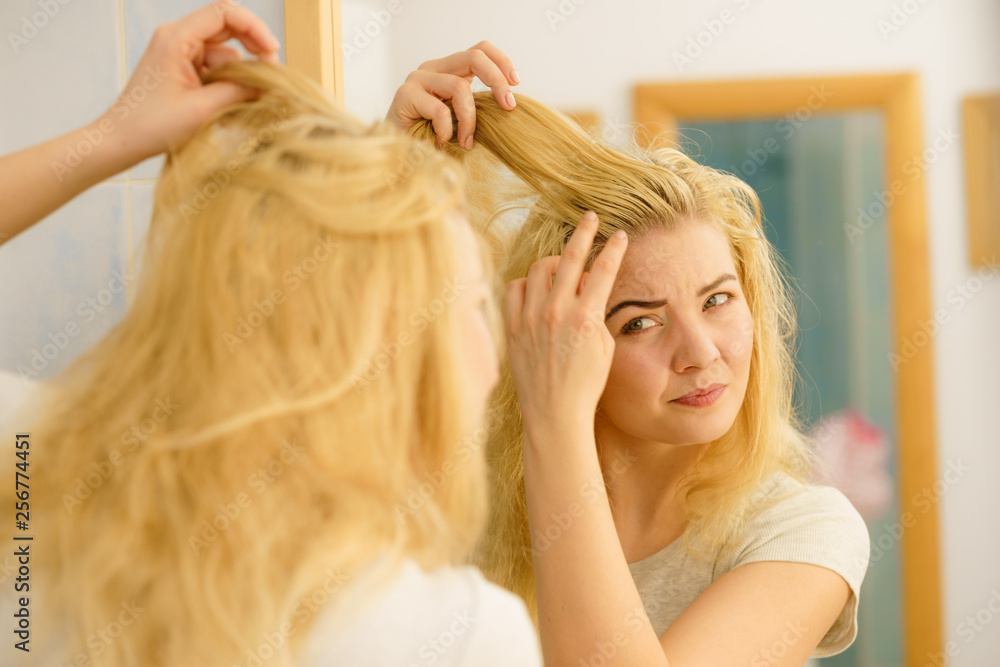 Fototapeta premium Female having problem with blonde hair