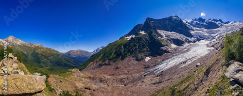 Huge mountain glacier in the surroundings of Dombai. Caucasus Mountains summer, clear day.