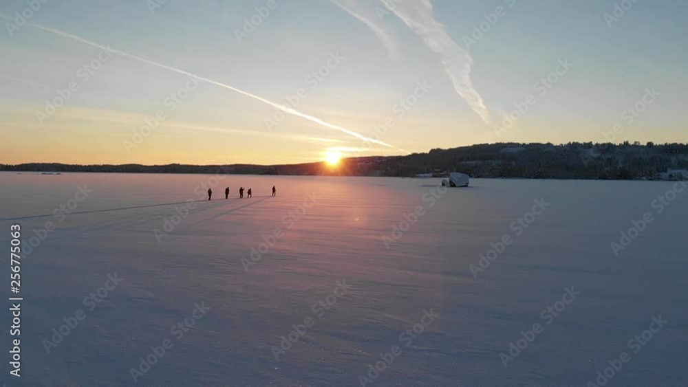 Cross-country Ski on a frozen Swedish lake in the sunset. Filmed with super slow motion and a drone. Cross-country Ski on a frozen Swedish lake in the sunset. Filmed with super slow motion and a drone.
