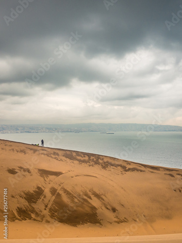 Gigant sand dune in Valparaiso bay, Concon, Chile. With the Valparaiso city in the back