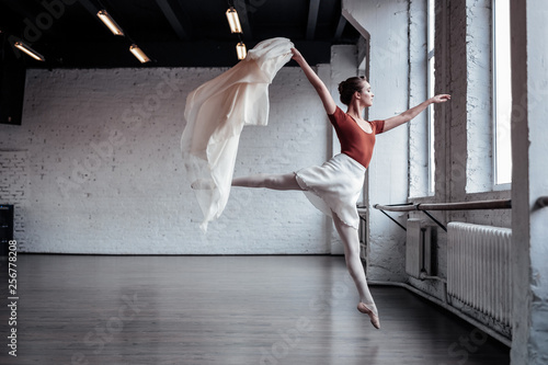 Attractive slim ballet dancer jumping during the dance