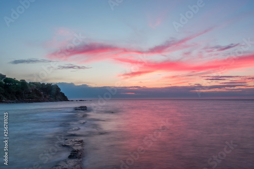 Long Exposure of a Sunset on the Southern Mediterranean Sea in Italy with Ancient Roman Wall