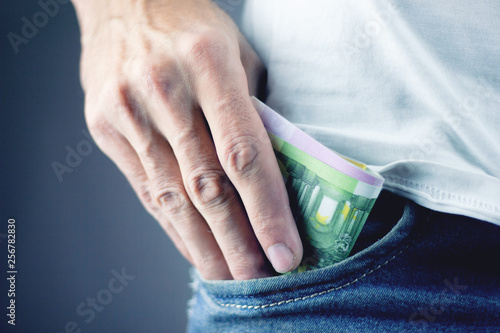 Man puts money in his pocket