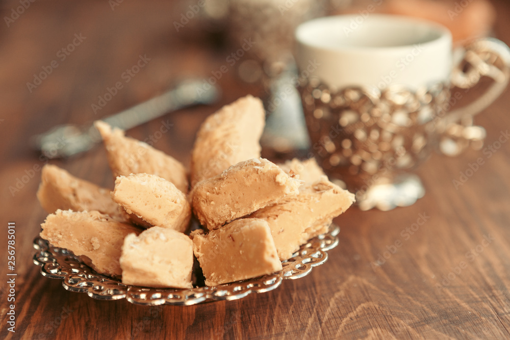Turkish sweets with coffee on a wooden table Turkish sweets with coffee on a wooden table
