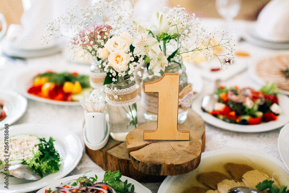 Decoration with number made with wood on a wedding table