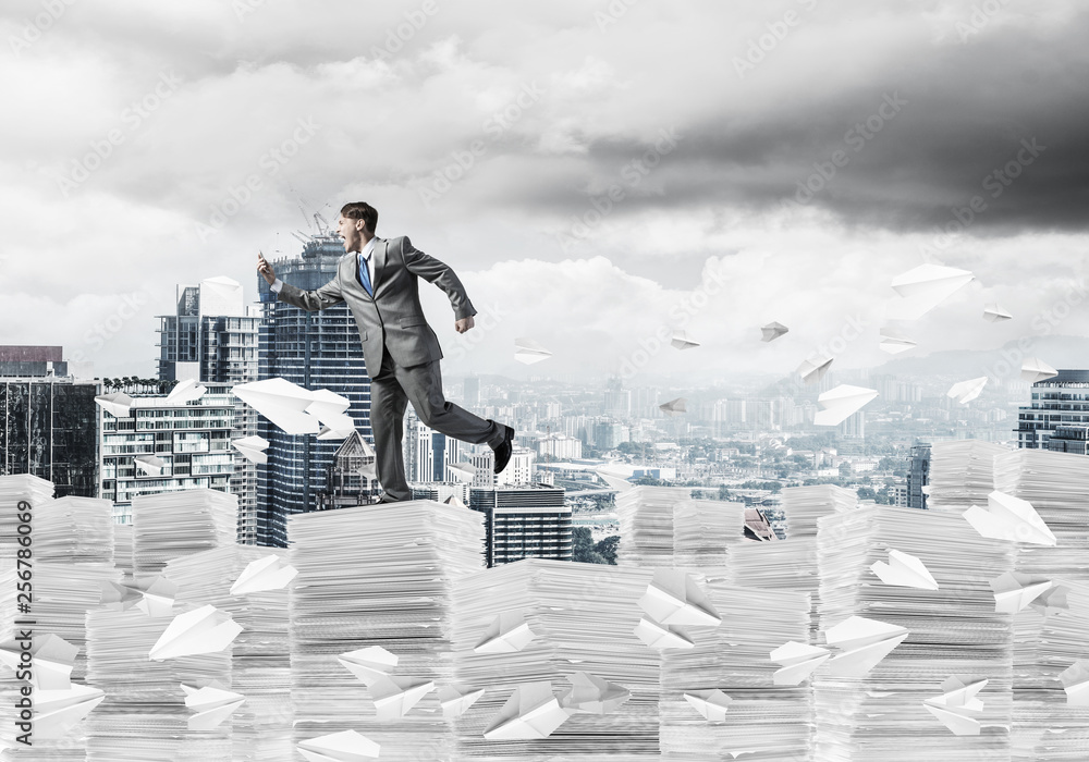 Precise businessman in suit running with phone. Precise businessman in suit running with phone.