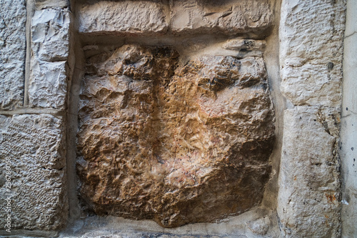 Via Dolorosa, Jerusalem, Israel. An old square stone with a cavity which is said to be the imprint of Jesus hand. Jerusalem sightseeings. The track left by Christ on stone wall while carrying cross. photo