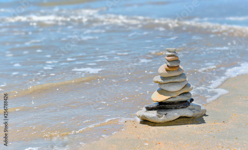 pebbles stacked on the seaside in sunny day in summer