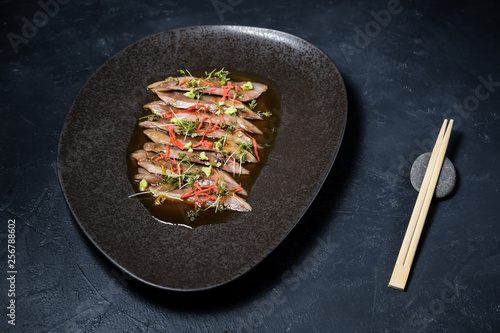 Sashimi tuna, carpaccio, black background, top view