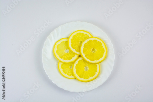 sliced lemons on a white plate
