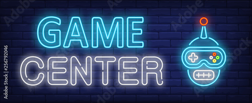 Game center neon text with funny gamepad cartoon character face