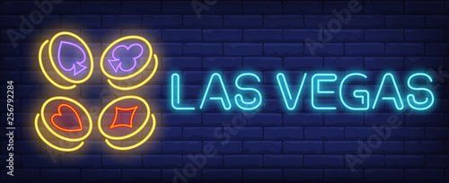 Photography Las Vegas neon text with playing card suit symbols on gold coins