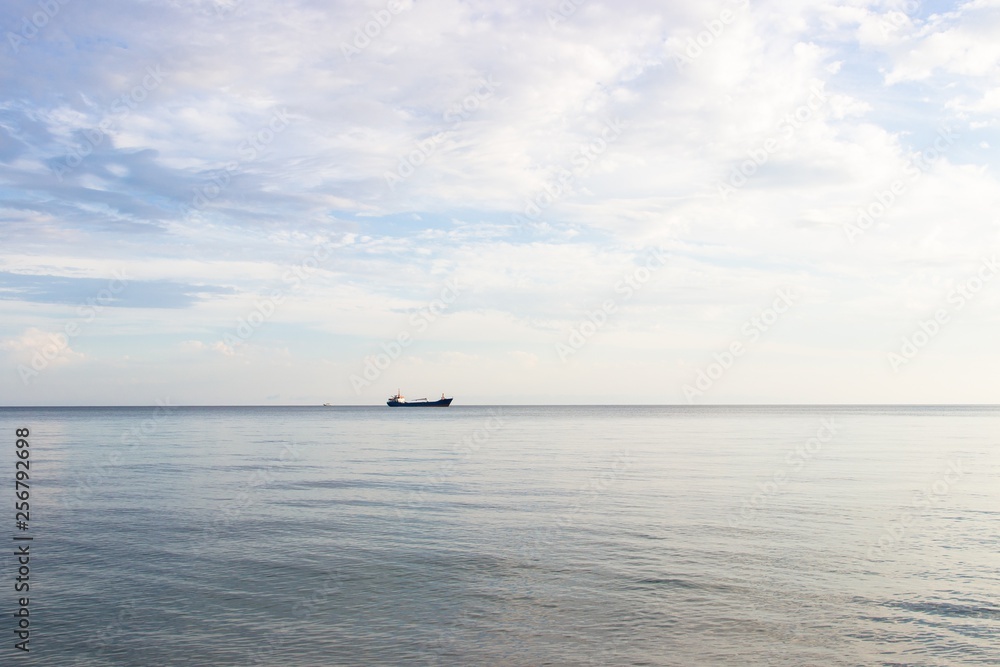 Tranquil seascape with ship at background Tranquil seascape with ship at background