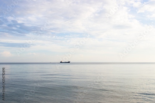 Tranquil seascape with ship at background © azamotkin