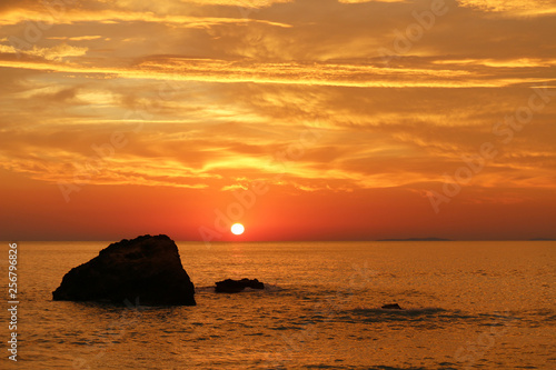 Orange sky over the Ionian sea with rock at sunset  Greece 