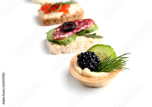 Fotografi Assortment of tasty canapes on white background