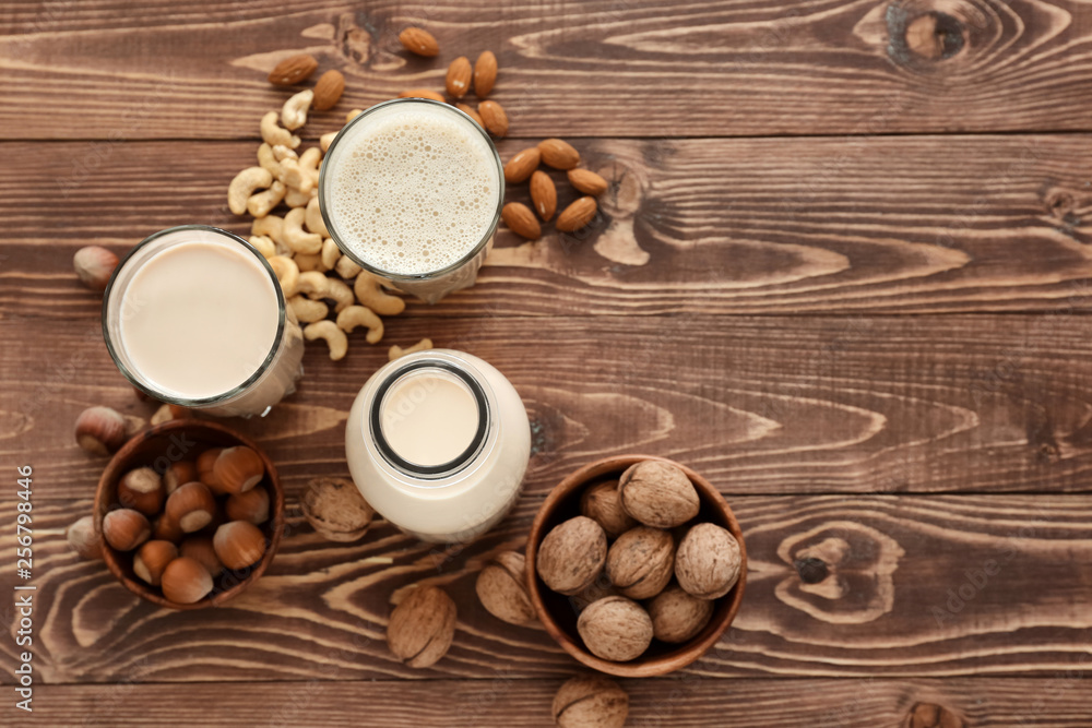 Assortment of tasty vegan milk on wooden table Assortment of tasty vegan milk on wooden table