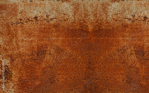 Panoramic rusty yellow-red textured metal surface. The texture of the metal sheet is prone to oxidation and corrosion. Textured background in grunge Style