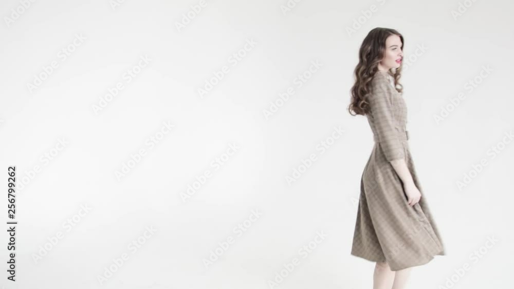 Beautiful cheerful girl in a beautiful dress dancing and laughing on a white background. Girl dancing in a Dress, spinning and having fun. 50 fps Beautiful cheerful girl in a beautiful dress dancing and laughing on a white background. Girl dancing in a Dress, spinning and having fun. 50 fps