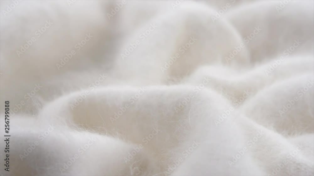 Soft wool background. Alpaca wool mohair clothes texture closeup. Natural cashmere fluffy merino wool. Woolen fabric. Rotated. 4K UHD video footage. 3840X2160 Soft wool background. Alpaca wool mohair clothes texture closeup. Natural cashmere fluffy merino wool. Woolen fabric. Rotated. 4K UHD video footage. 3840X2160